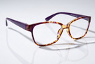 Eyelevel-UK Topaz reading glasses with a purple and multi-coloured square frame and clear magnifying lenses.