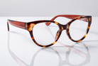 Eyelevel-UK Windsor cat-eye reading glasses with a brown tortoiseshell plastic frame on a reflective white surface