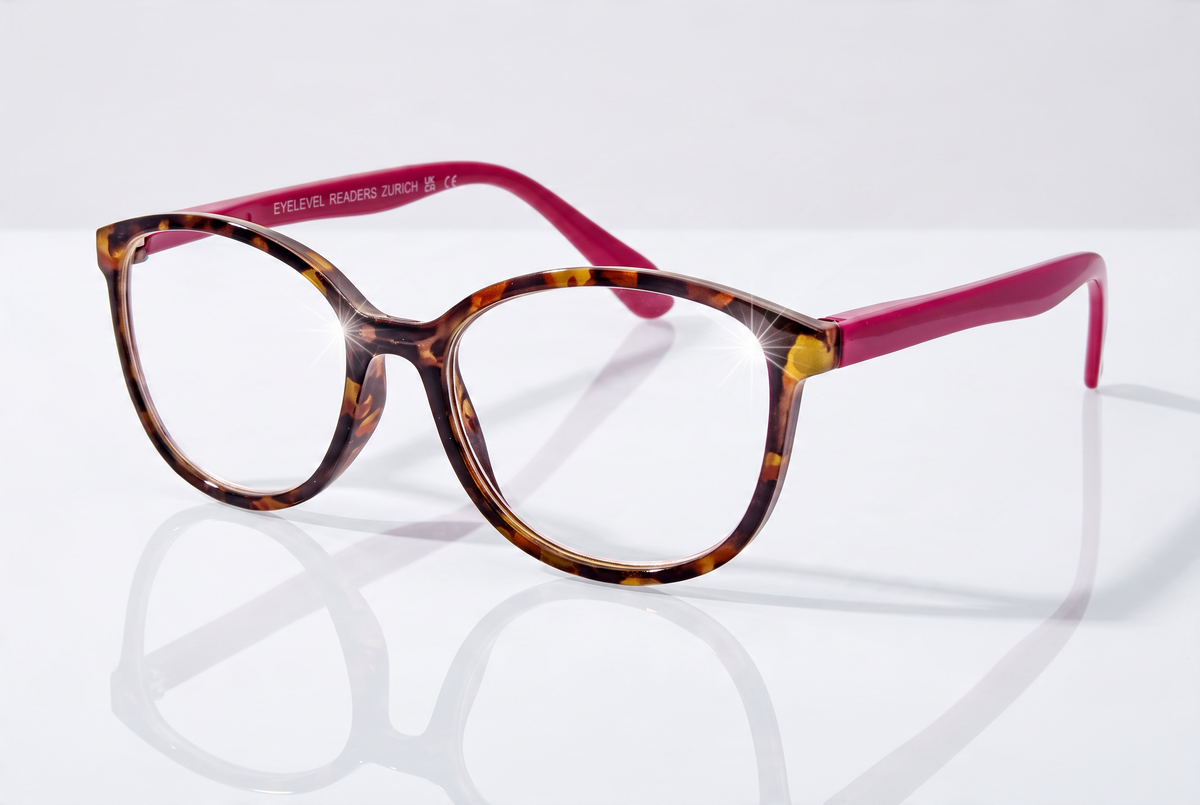 Eyelevel-UK Zurich reading glasses with tortoiseshell square frames and berry-pink temples on a reflective surface.